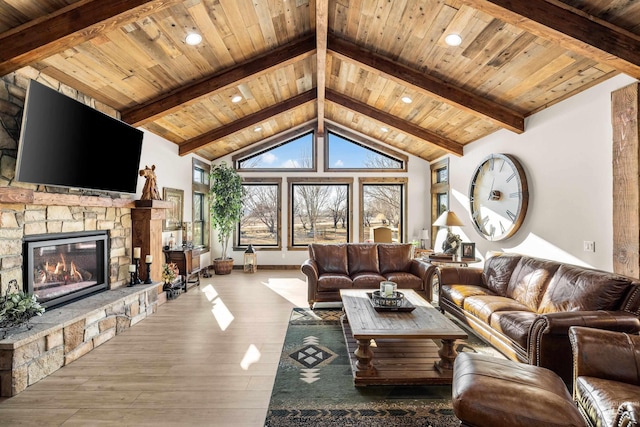 living room featuring a stone fireplace, hardwood / wood-style floors, high vaulted ceiling, beamed ceiling, and wooden ceiling