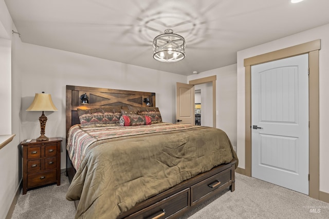 carpeted bedroom featuring a chandelier