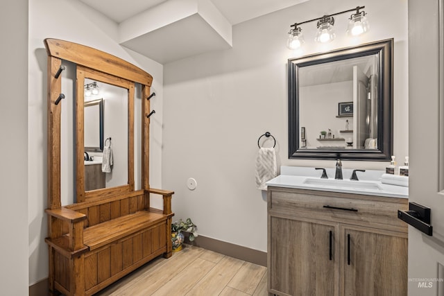 bathroom with hardwood / wood-style flooring and vanity