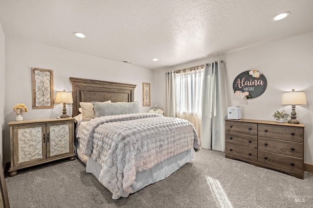 carpeted bedroom featuring a textured ceiling