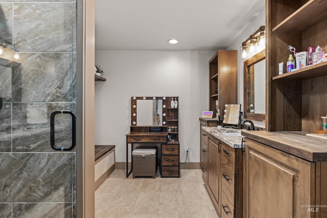 bathroom with walk in shower and vanity