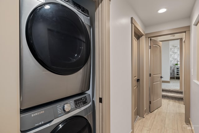 washroom featuring stacked washer / dryer and light wood-type flooring