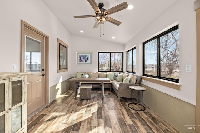 living room with breakfast area, beverage cooler, vaulted ceiling, and hardwood / wood-style floors