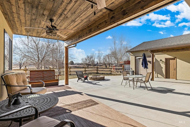 view of patio / terrace featuring a fire pit and ceiling fan