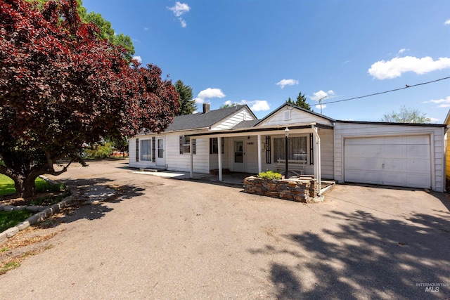 1402 Southside Blvd, Nampa, ID 83686 - single story home featuring an attached garage, driveway, covered porch, and a chimney