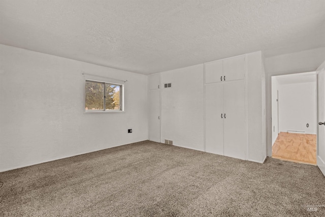 1402 Southside Blvd, Nampa, ID 83686 - unfurnished bedroom featuring a textured ceiling, carpet floors, and a closet