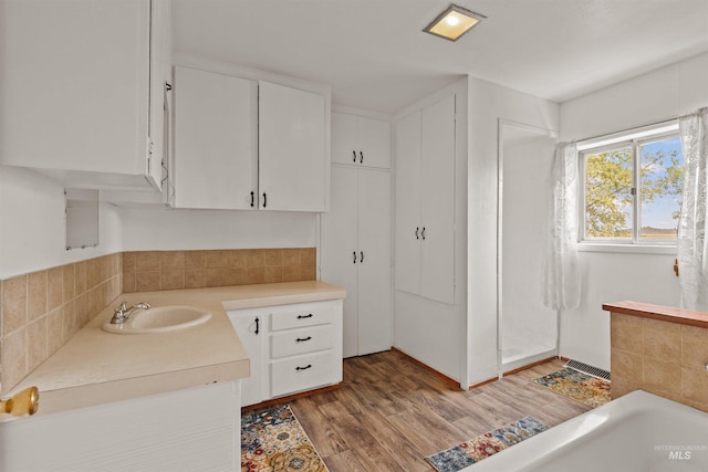 1402 Southside Blvd, Nampa, ID 83686 - bathroom featuring wood finished floors, vanity, a bath, and a shower
