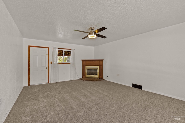 1402 Southside Blvd, Nampa, ID 83686 - unfurnished living room featuring ceiling fan, a textured ceiling, carpet, a glass covered fireplace, and baseboards