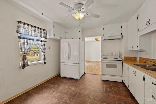 1402 Southside Blvd, Nampa, ID 83686 - kitchen with white appliances, under cabinet range hood, ceiling fan, a sink, and white cabinets