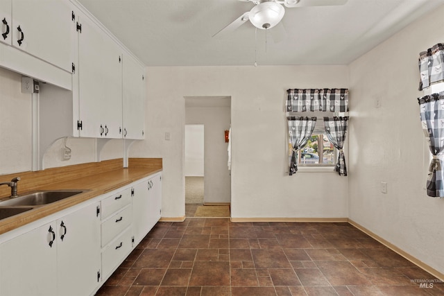 1402 Southside Blvd, Nampa, ID 83686 - kitchen with ceiling fan, baseboards, white cabinets, and light countertops
