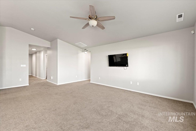 carpeted spare room featuring ceiling fan and lofted ceiling