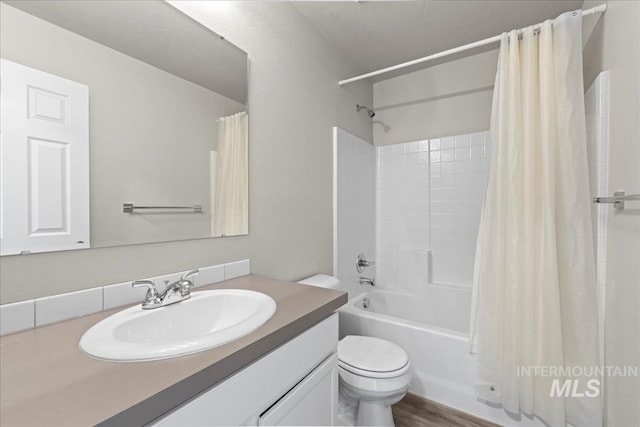 full bathroom featuring hardwood / wood-style floors, vanity, shower / bath combo, and toilet