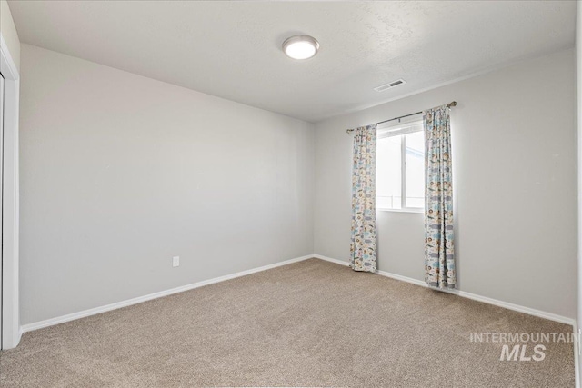 unfurnished room with carpet flooring