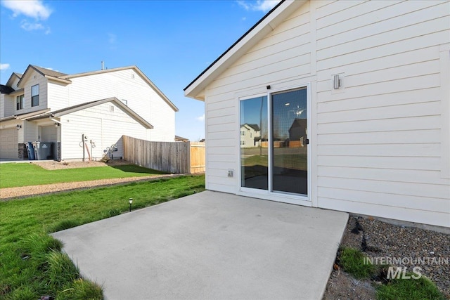 rear view of property featuring a yard and a patio