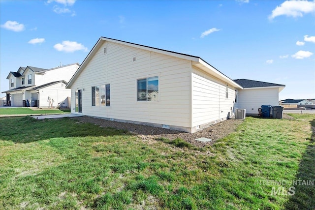 view of home's exterior with central AC unit and a yard