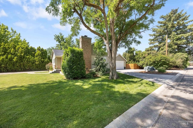 1309 S Pacific St, Boise, ID 83705 - obstructed view of property featuring driveway, a chimney, a detached garage, and a front lawn