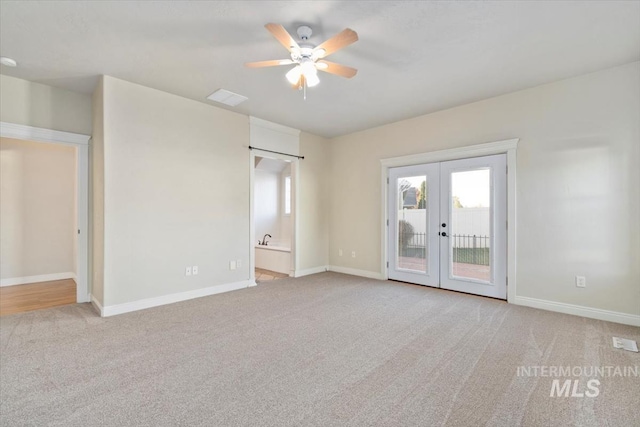 unfurnished bedroom with access to outside, french doors, light colored carpet, and baseboards