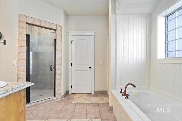 bathroom featuring a shower stall, tile patterned flooring, a garden tub, and plenty of natural light