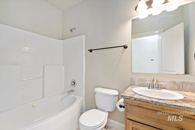 full bath featuring vanity, toilet, baseboards, and shower / bath combination