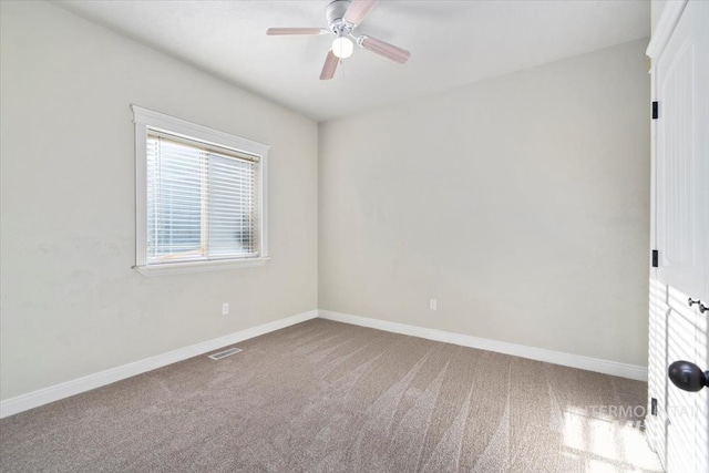 empty room featuring a ceiling fan, carpet flooring, and baseboards