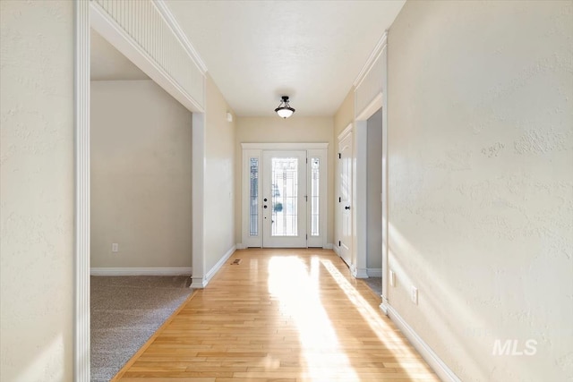 entryway featuring light wood-style floors and baseboards