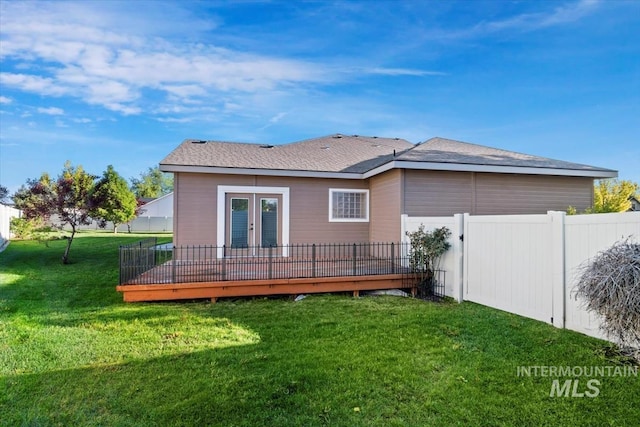 rear view of house with french doors and a wooden deck