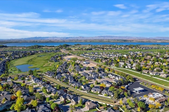 view of property location with nearby suburban area and a water and mountain view