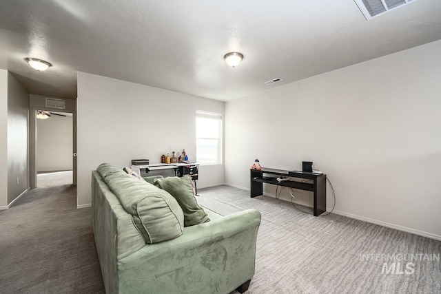 living room with carpet flooring, visible vents, and baseboards