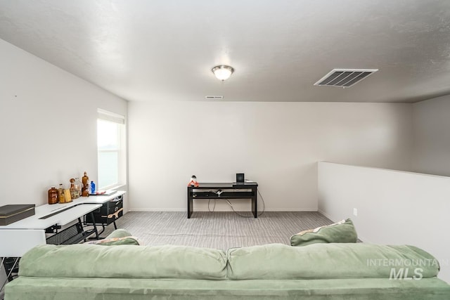 living room featuring carpet floors, baseboards, and visible vents