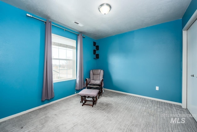 unfurnished room with carpet floors, visible vents, and baseboards