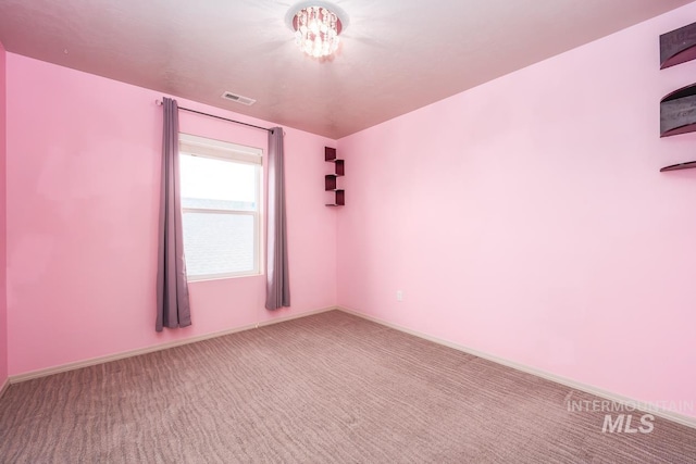 empty room with carpet floors and baseboards