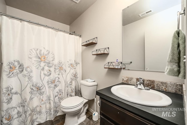 full bath with visible vents, vanity, and toilet