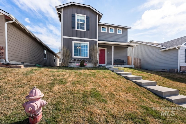 traditional home featuring a front lawn, board and batten siding, and brick siding