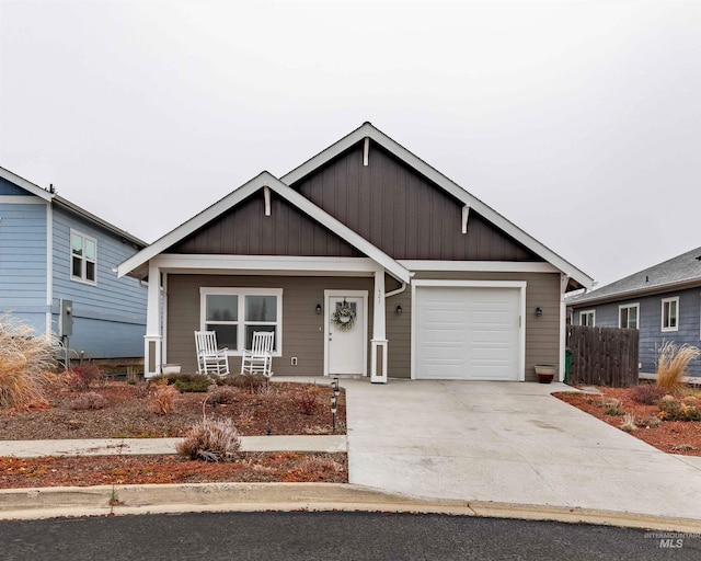 view of front of property with covered porch and a garage