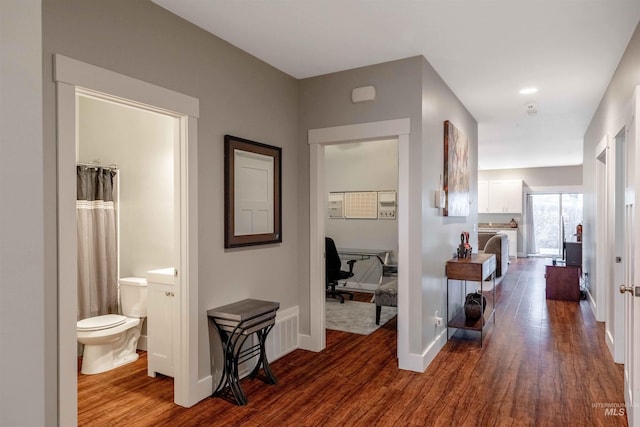 hallway featuring dark hardwood / wood-style flooring