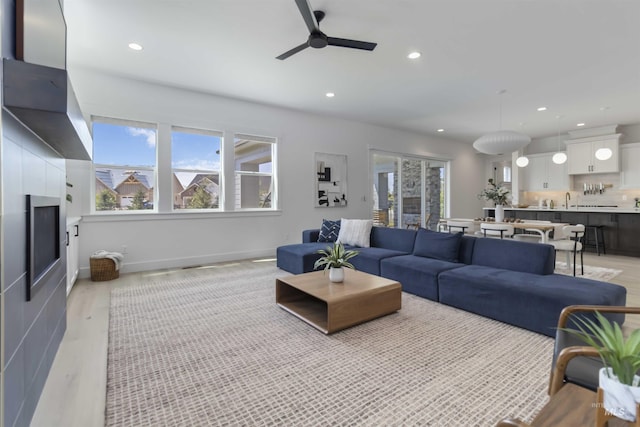 125 S Eagles Roost Way, Eagle, ID 83616 - living room with ceiling fan, recessed lighting, and light wood-style flooring