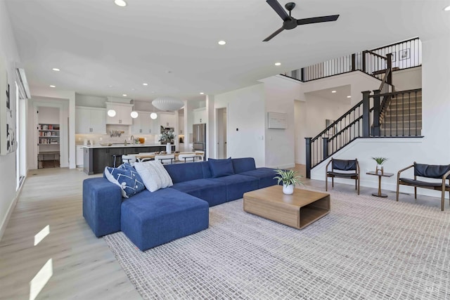 125 S Eagles Roost Way, Eagle, ID 83616 - living area with light wood-style flooring, ceiling fan, stairs, and recessed lighting
