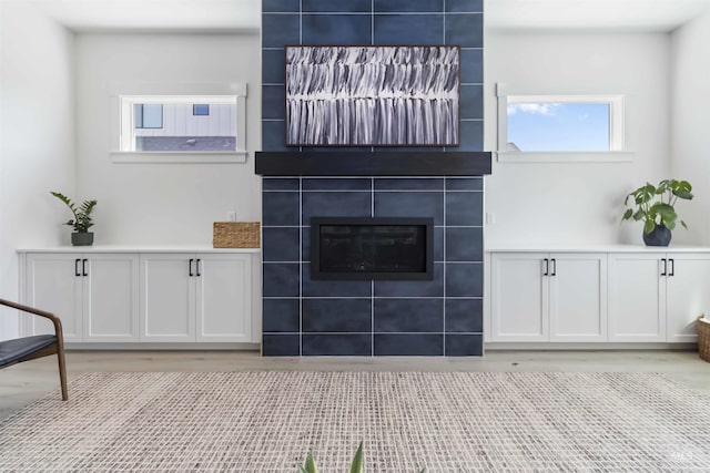 125 S Eagles Roost Way, Eagle, ID 83616 - unfurnished living room with light wood finished floors and a tile fireplace