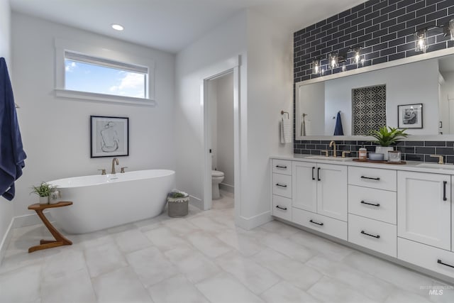 125 S Eagles Roost Way, Eagle, ID 83616 - bathroom featuring double vanity, backsplash, a freestanding tub, and recessed lighting