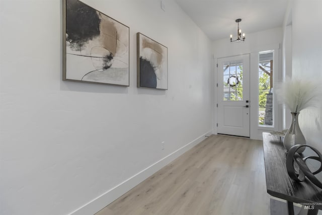 125 S Eagles Roost Way, Eagle, ID 83616 - foyer with a chandelier and wood finished floors