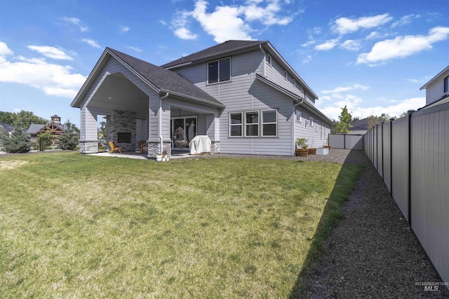125 S Eagles Roost Way, Eagle, ID 83616 - back of house with a fenced backyard, a patio area, and a shingled roof
