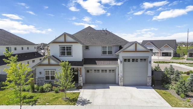 125 S Eagles Roost Way, Eagle, ID 83616 - view of front of property with stone siding, a shingled roof, concrete driveway, and a garage