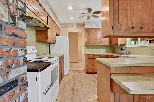 kitchen with a sink, white appliances, light countertops, a ceiling fan, and under cabinet range hood