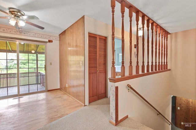 interior space featuring visible vents, a ceiling fan, baseboards, and carpet