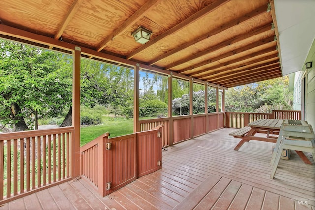 wooden terrace featuring a yard
