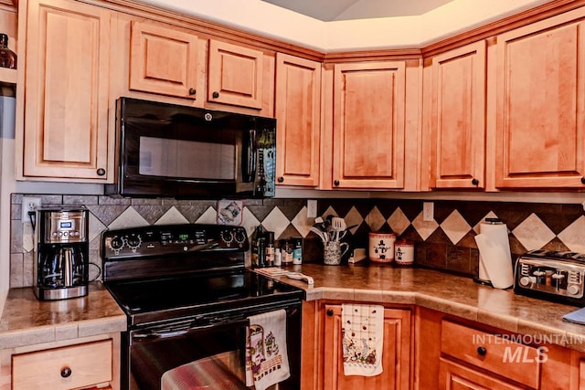 12 Blue Spruce Ct, Cascade, ID 83611 - kitchen featuring black appliances, decorative backsplash, and tile counters