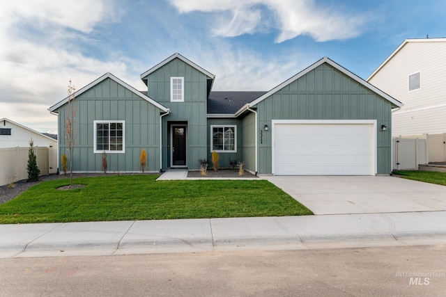 view of front of house with board and batten siding, an attached garage, a front yard, and fence