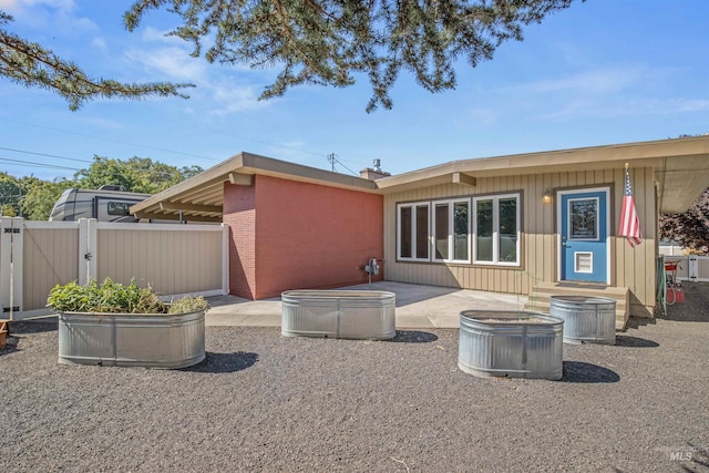 rear view of property featuring a patio