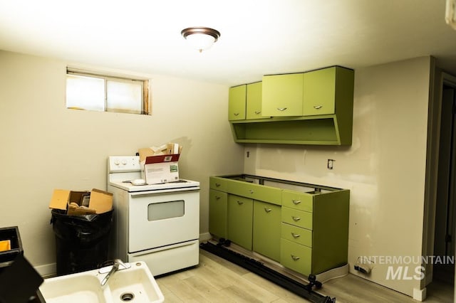 kitchen featuring white electric range oven, light wood-style floors, and green cabinetry