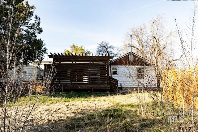 back of property featuring a pergola